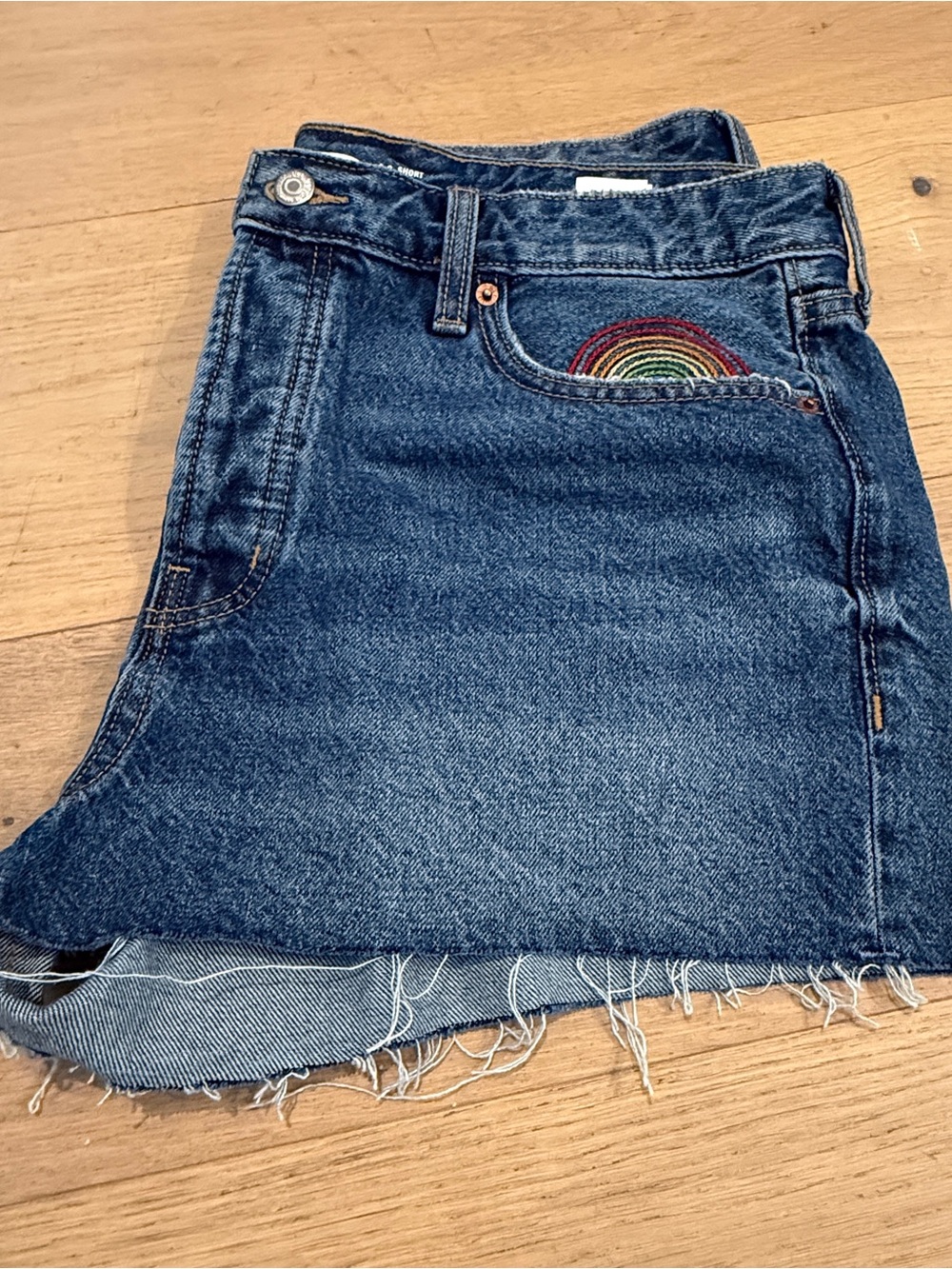 Old Navy denim shorts with rainbow pocket embroidery